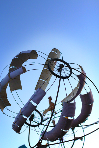 A wind sculpture at Avalon Gardens is made of reclaimed parts and recyclable materials such as tin cans. Photo by Global Change Media.
